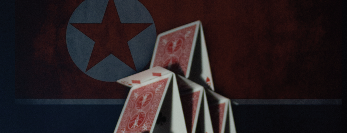 Stack of cards in front of the North Korean flag.