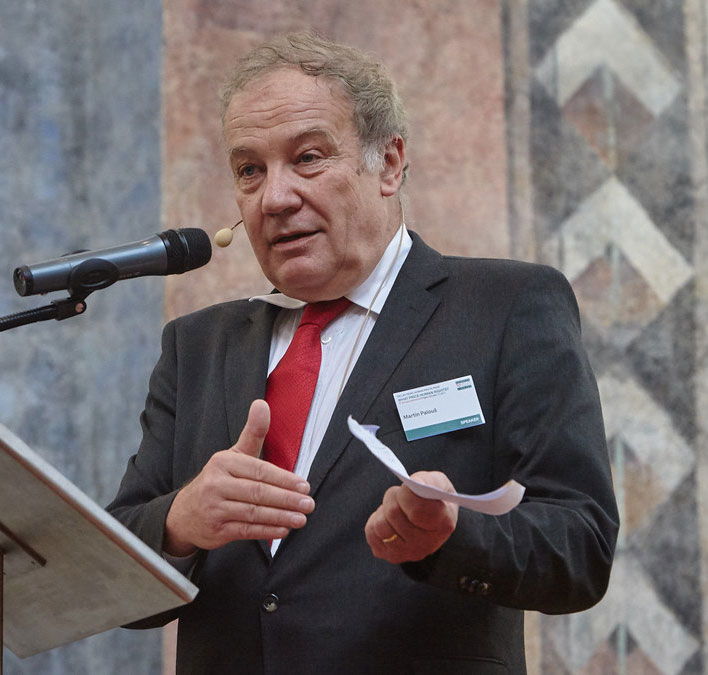 Martin Palous on a podium giving a speech.