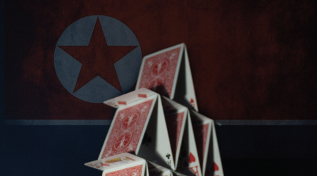 Stack of cards in front of the North Korean flag.